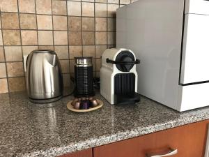 a kitchen counter with a coffee maker and a toaster at Mystra Place in Nicosia