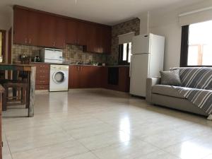 a kitchen with a couch and a refrigerator in a room at Mystra Place in Nicosia +6 photos