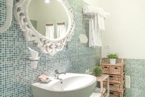 a bathroom with a white sink and a mirror at B&B Aurora Salentina in Morciano di Leuca