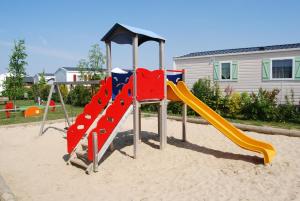 a playground with a slide in the sand at Camping Le Walric in Saint-Valéry-sur-Somme