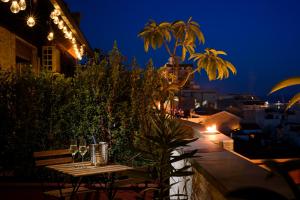 einen Tisch mit Weingläsern auf dem Balkon in der Nacht in der Unterkunft B&B AL PASSIO in Palermo