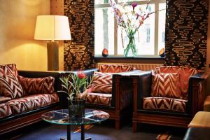 a living room with two leather couches and a table at Banks Mansion - All Inclusive Boutique Hotel in Amsterdam +45 photos