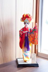 a figurine of a woman in a kimono on a table at Gran kodachi in Fujikawaguchiko