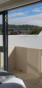 a bedroom with a view of a roof at Waterfront - Lagoon Terrace Nr.17 in Knysna