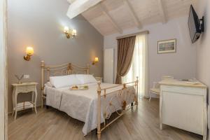 Postel nebo postele na pokoji v ubytování Le torri di Tarquinia