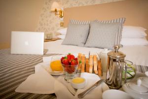 A bed or beds in a room at Glen-Yr-Afon House Hotel