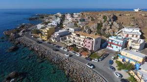 an aerial view of a town next to the ocean at On The Rocks in Palaiochora +33 photos