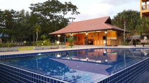 a swimming pool in front of a house at Raintree Bangsak in Khao Lak
