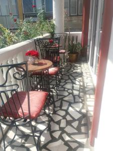 
a patio area with chairs, tables, chairs and umbrellas at Guest House Vivaldi in Niš
