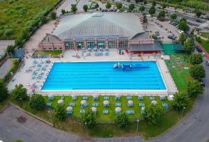 an overhead view of a large swimming pool with umbrellas at Mansarda Lina in Casarza Ligure