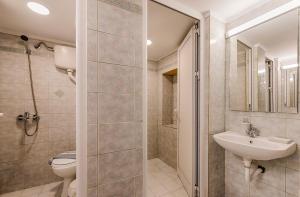 a bathroom with a sink and a toilet and a shower at Knights Of Old Town in Rhodes Town