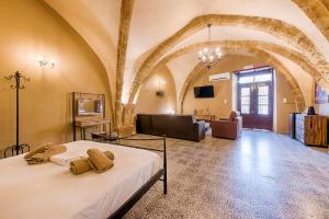 a bedroom with a bed and a living room at Knights Of Old Town in Rhodes Town