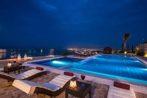 a swimming pool at night with a view at Villa Bella Mare, Wine Dark Sea Villas in Rodia