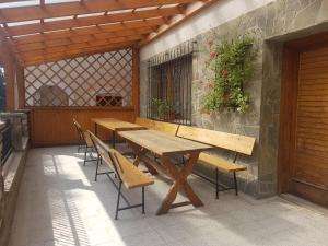 a wooden table and chairs on a patio at Sklep u Kunických in Vracov