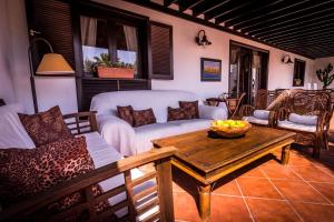 sala de estar con sofá y mesa en Villa Carmen Lanzarote, en Costa Teguise