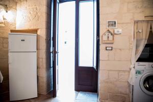 a door to a kitchen with a washer and dryer at nonna annina in Martina Franca