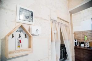 a room with a clock on the wall with a window at nonna annina in Martina Franca +53 photos