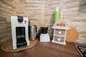 a kitchen counter with a coffee maker and other appliances at nonna annina in Martina Franca