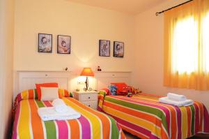 a bedroom with two beds and a window at Hacienda del Alamo Golf in Fuente Alamo +132 photos