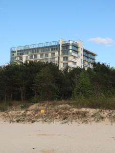a building on the beach in front of a building at Wechta E5 in Międzyzdroje +7 photos