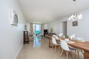 a dining room and living room with a table and chairs at Ocean Front 1 bedroom at Tides Hollywood 11th in Hollywood