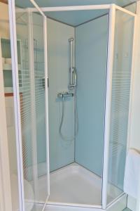 a shower with a glass enclosure in a bathroom at Hotelboat Fleur in Amsterdam