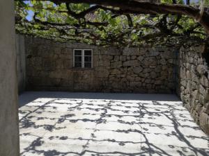 a room with a stone wall and a window at Casa de Paulus - Gerês in Geres