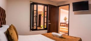 Voodi või voodid majutusasutuse Hotel Alamos Del Parque toas