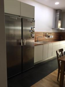 a kitchen with a stainless steel refrigerator and a table at Casa Del Casco Historico in Las Lagunas