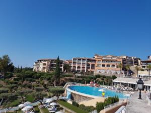 a view of a resort with a swimming pool at Appartement à Cap Estérel Village Pierre et Vacances Piscines et parking inclus in Agay - Saint Raphael