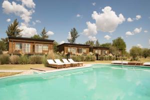 a house with a swimming pool in front of a house at Posada Las Aguas in Gualeguaychú