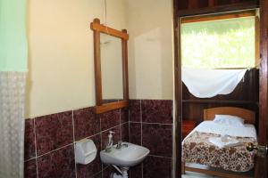 a bathroom with a sink and a mirror at Paradise Amazon Tambopata Ecolodge in Puerto Maldonado