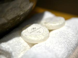 three pieces of white soap sitting on top of towels at The Cayley Arms Inn in Pickering