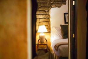 a bedroom with a bed and a lamp in a room at El Carmen Hotel in Antigua Guatemala