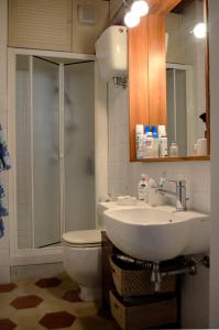 a bathroom with a sink and a toilet and a shower at Casa di Luli in Siena