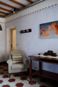 a room with a chair and a desk and a table at Casa di Luli in Siena