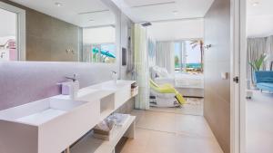 a bathroom with two sinks and a large mirror at The Hype Beachhouse in Playa de Palma