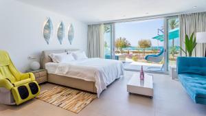 a bedroom with a bed and a blue chair at The Hype Beachhouse in Playa de Palma