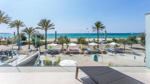 a view of the beach from the balcony of a resort at The Hype Beachhouse in Playa de Palma