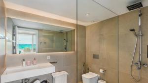 a bathroom with a shower and a toilet and a mirror at The Hype Beachhouse in Playa de Palma