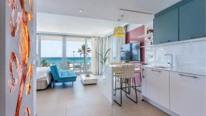 a kitchen and living room with a view of the ocean at The Hype Beachhouse in Playa de Palma