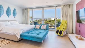 a bedroom with a bed and a yellow chair at The Hype Beachhouse in Playa de Palma