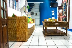 a room with two wicker chairs and a table at Blue Hostel in Natal