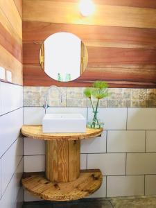 a bathroom with a sink and a mirror at Rema K A Y A K Lodge in Tena