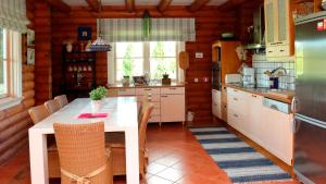 a kitchen with a white table and a table and chairs at Veerpalu Villa in Otepää