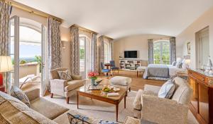 a living room with a couch and a bed at Château Saint-Martin & Spa - an Oetker Collection Hotel in Vence