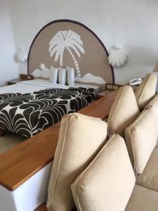 a hotel room with a bed and a bunch of chairs at Palma Real in Manzanillo
