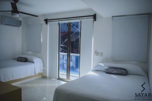 Postel nebo postele na pokoji v ubytování Hotel Sayab 5ta Avenida