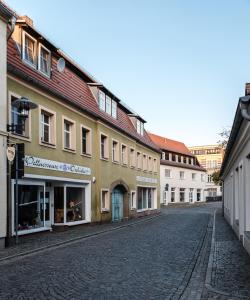 a cobblestone street in a town with buildings at Buri Island in Hoyerswerda