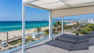 a view of the beach from the balcony of a condo at The Hype Beachhouse in Playa de Palma